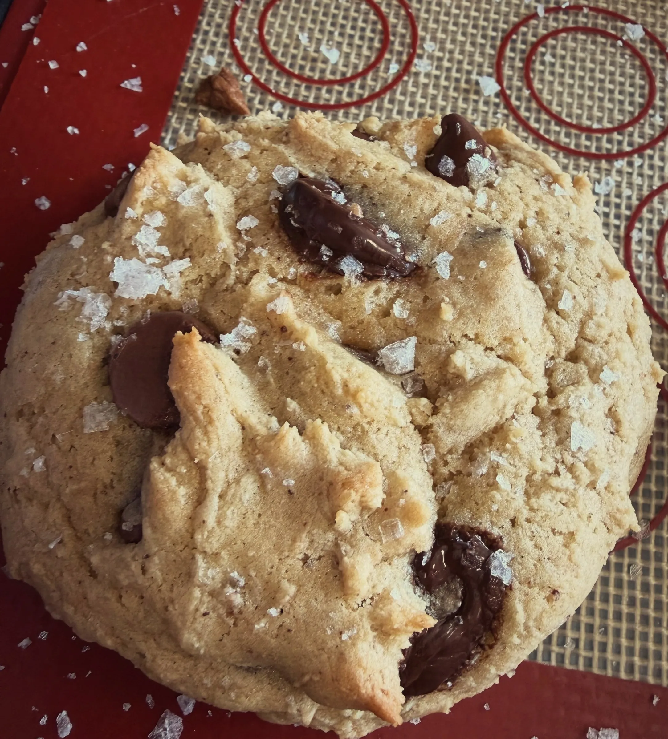 A brown butter chocolate chip cookie topped with flaky salt