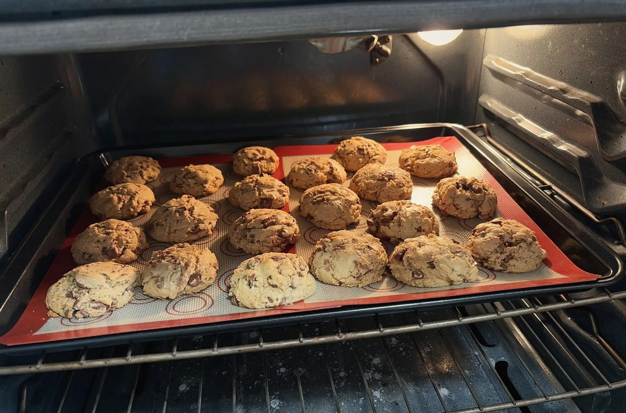 A tray of chocolate chip cookies baking in the oven